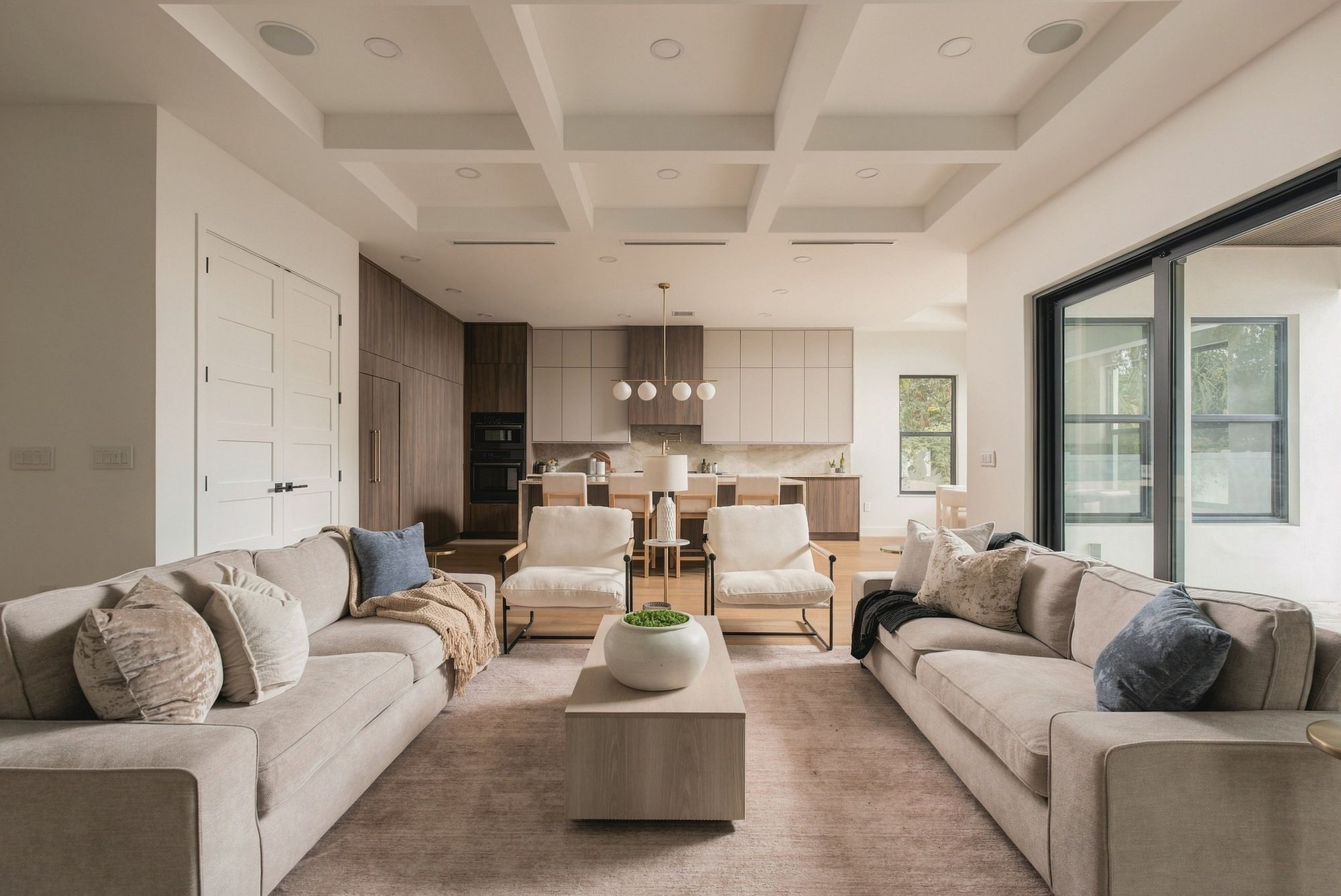 Open-plan living room and kitchen with a waterfall island