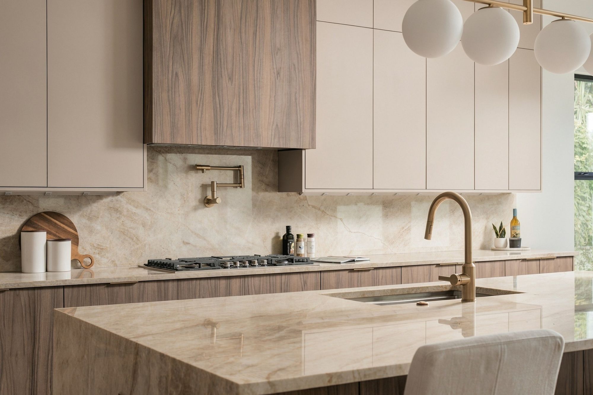 Detail of a brass faucet and a stone waterfall island