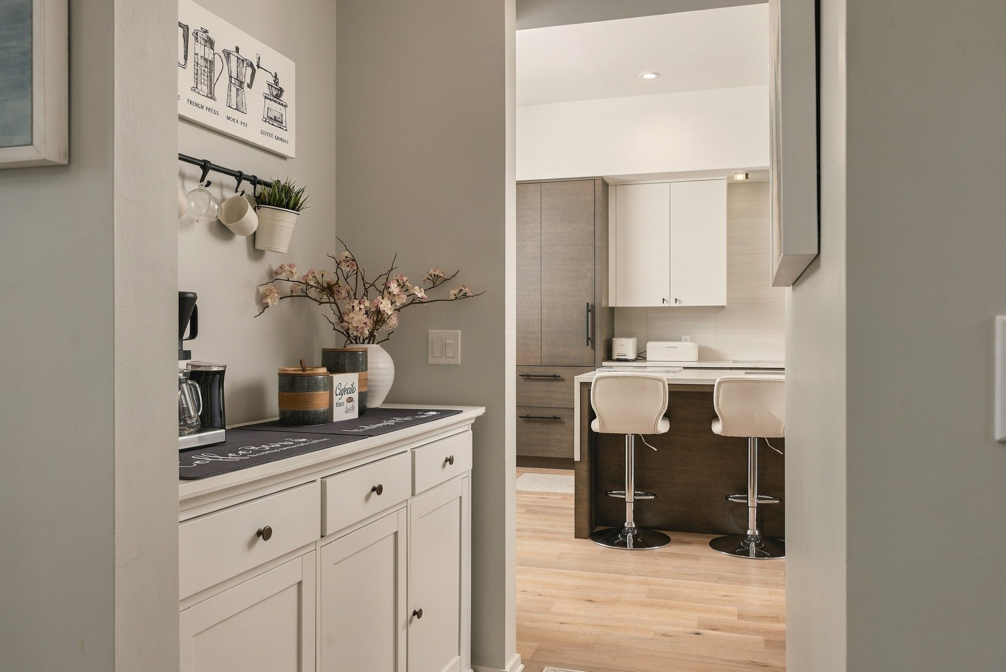 Coffee bar nook with white cabinetry and a view through to the kitchen